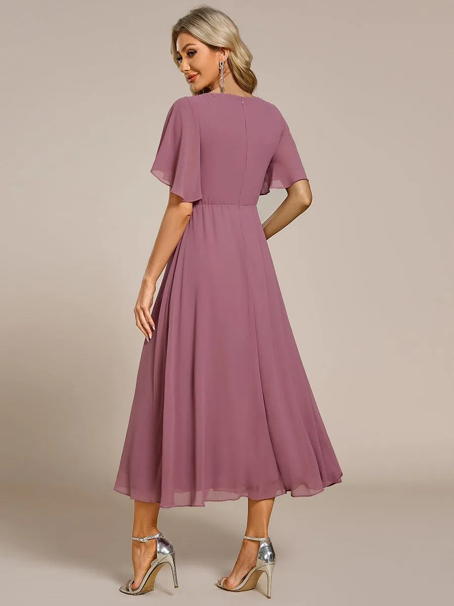 Robe d'invité de mariage mi-longue en mousseline à col en V avec appliques à la taille