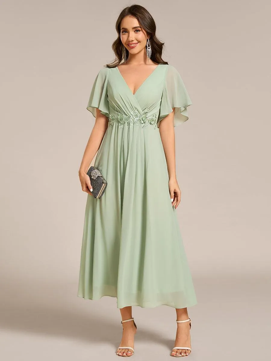 Robe d'invité de mariage mi-longue en mousseline à col en V avec appliques à la taille